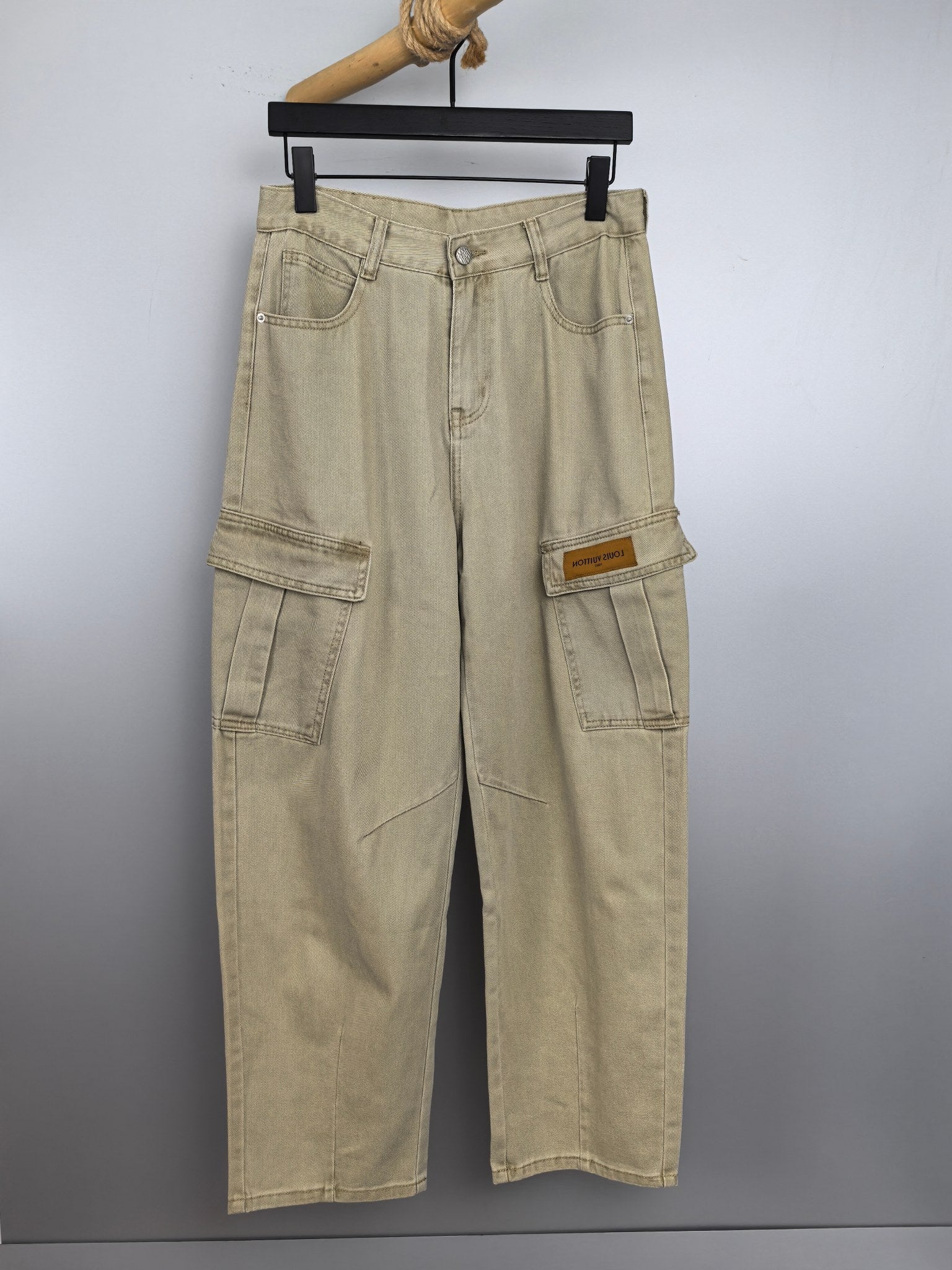 Beige denim cargo pants with belt loops and front button closure