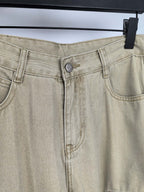 Beige denim pants close-up of waistband seams and front metal button