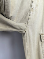 Beige denim pants close-up of inner thigh seam and stitched crotch