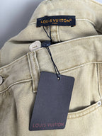 Beige denim jacket-style neckline label with attached Louis Vuitton tag