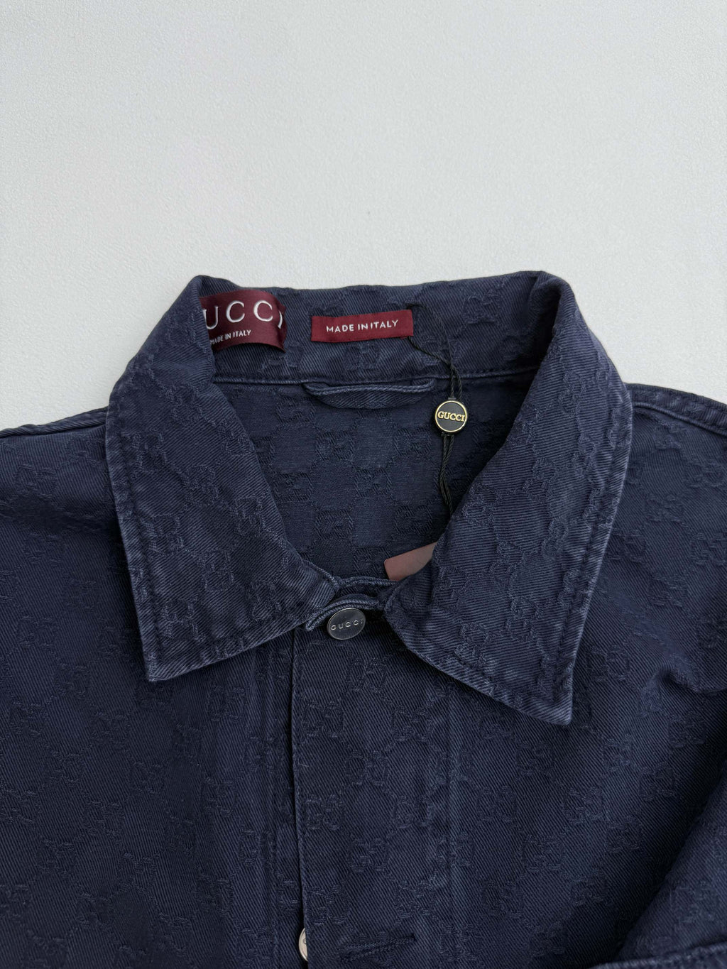Gucci denim jacket collar with snap buttons and textured dark navy fabric