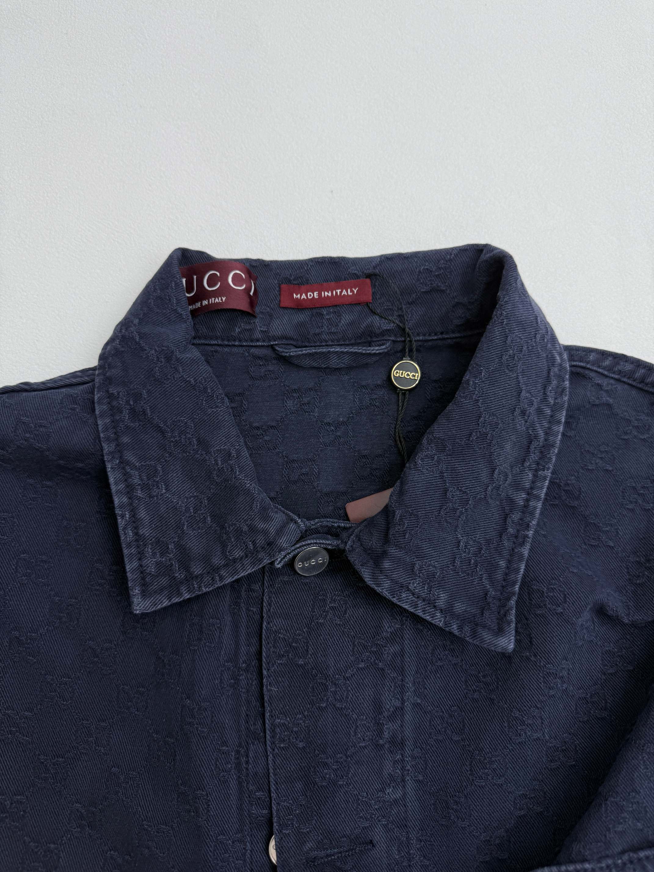 Gucci denim jacket collar with snap buttons and textured dark navy fabric