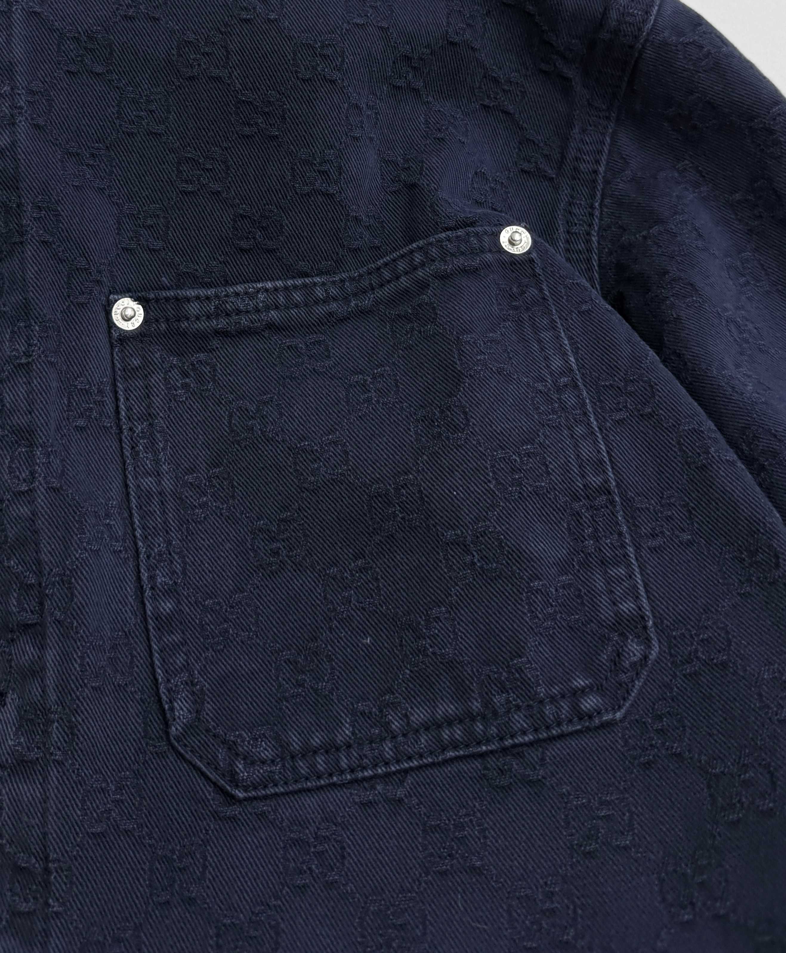 Gucci denim jacket chest pocket with snap buttons on dark navy fabric