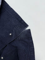 Gucci denim jacket sleeve and shoulder seam with snap buttons on dark navy