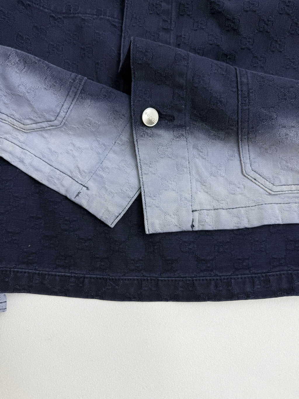 Gucci denim jacket cuff and sleeve placket with snap button closure