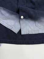 Gucci denim jacket cuff and sleeve placket with snap button closure