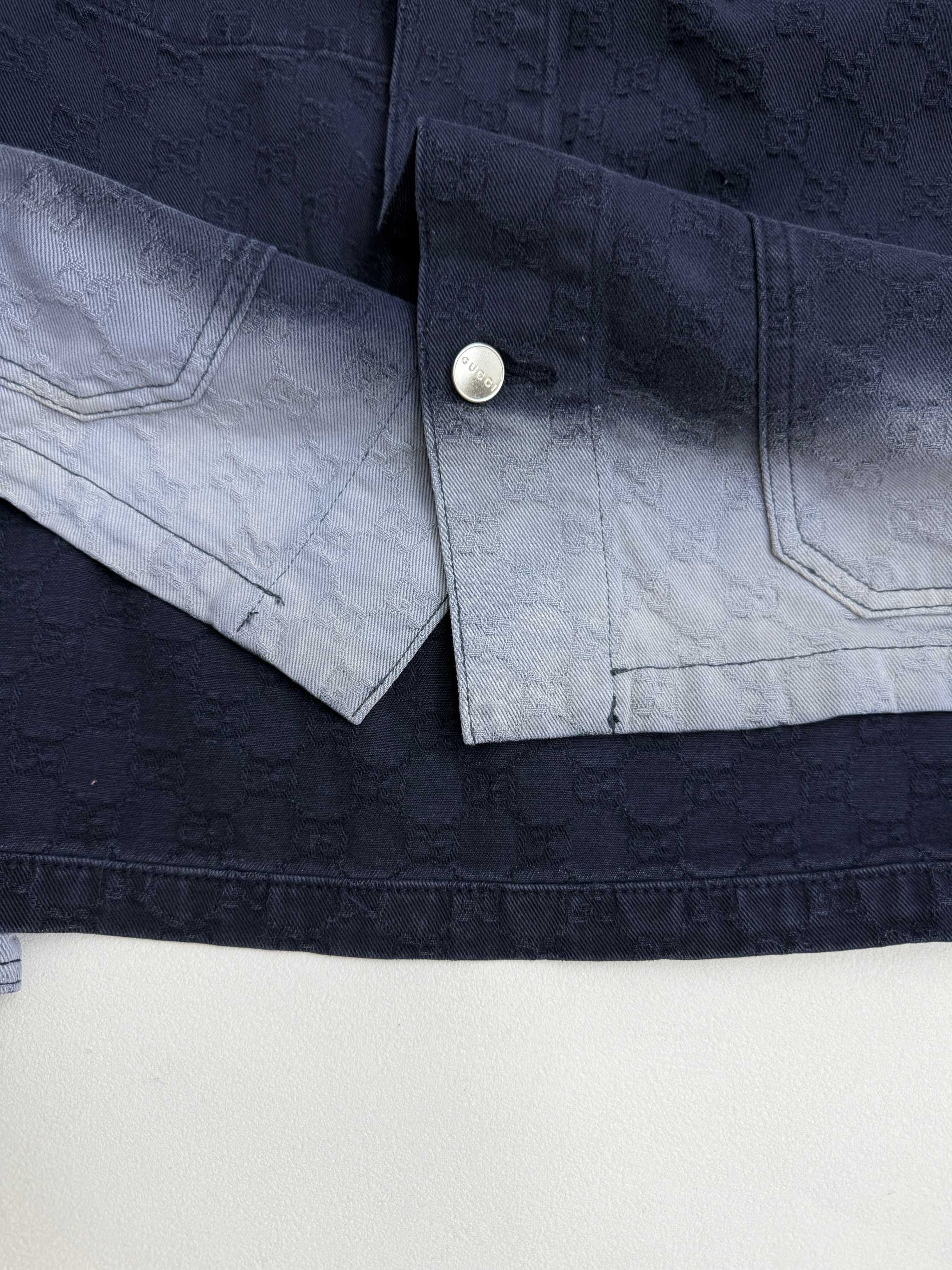 Gucci denim jacket cuff and sleeve placket with snap button closure
