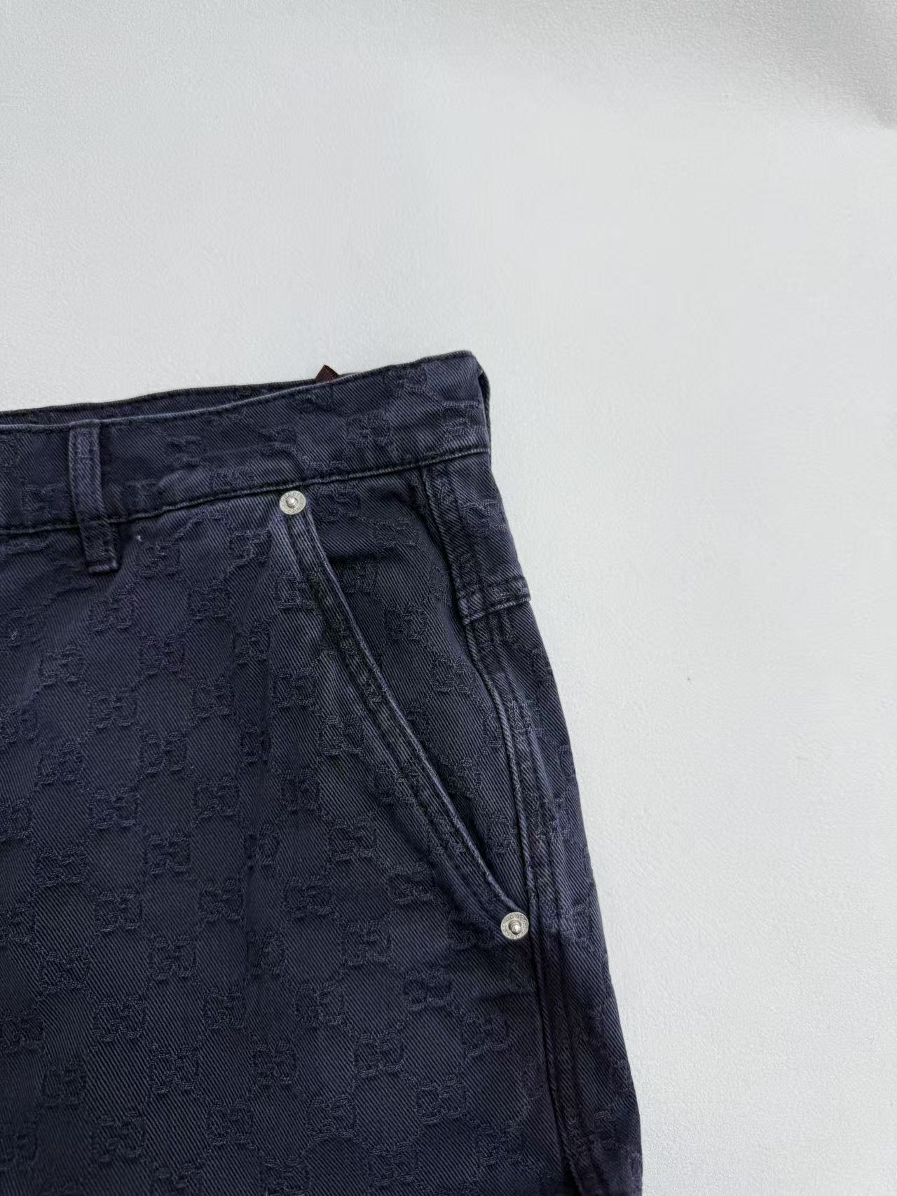 Navy Gucci pants back yoke close-up, metal button detail, GG pattern fabric