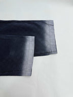 Navy Gucci pants hem close-up, side seam and cuff finish on GG-pattern fabric