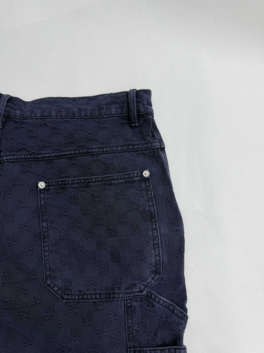 Navy Gucci pants back pocket close-up, stitched patch pocket, GG pattern