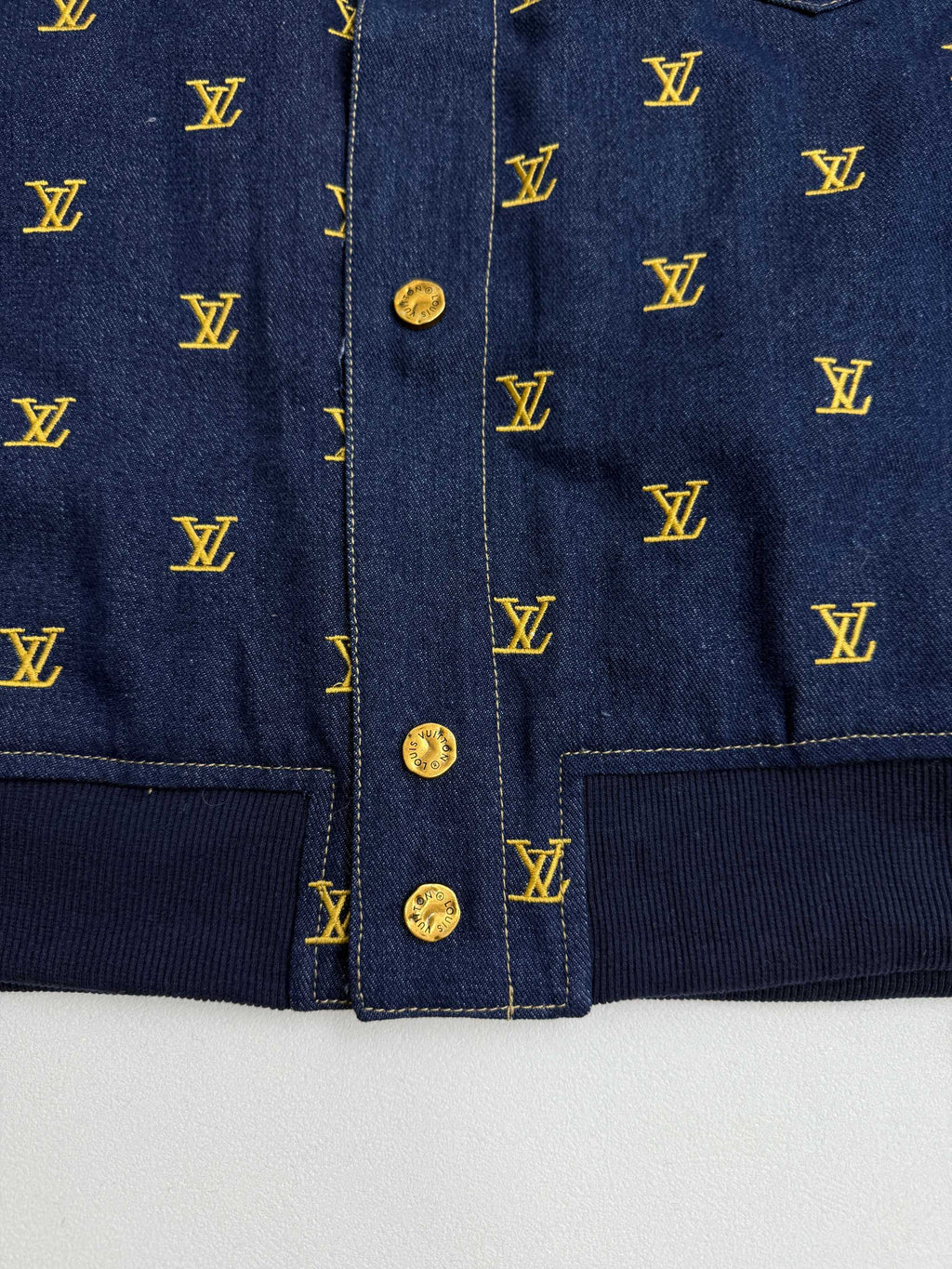 Louis Vuitton denim jacket front placket with gold buttons and yellow monogram