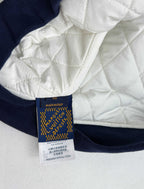 Louis Vuitton garment label on navy ribbed hem with care and size text
