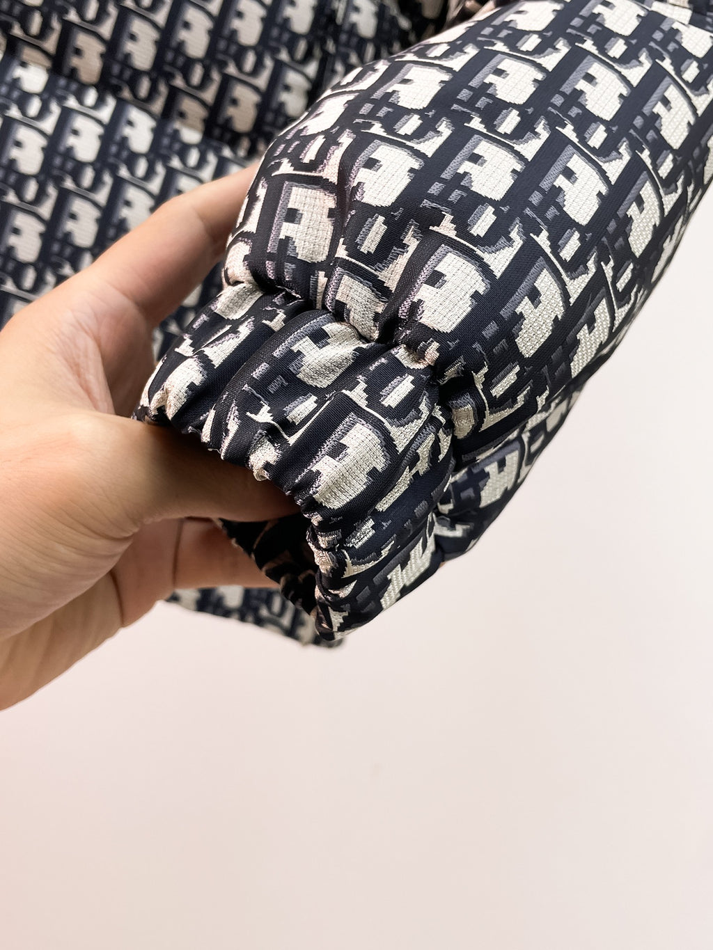 Dior logo-print jacket cuff with elastic hem and black drawcord close-up