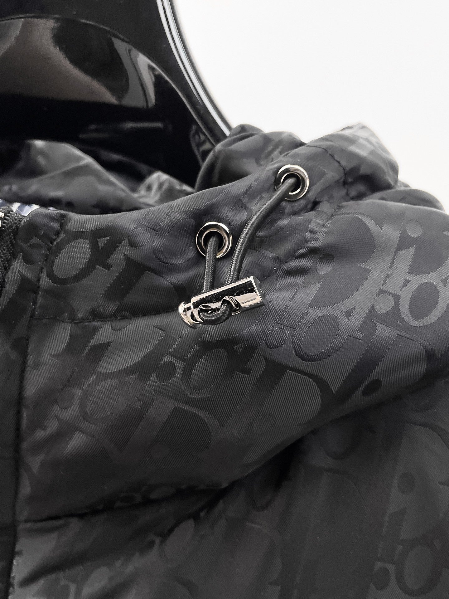 Dior hooded puffer jacket close-up, front drawstring cord with metal ring