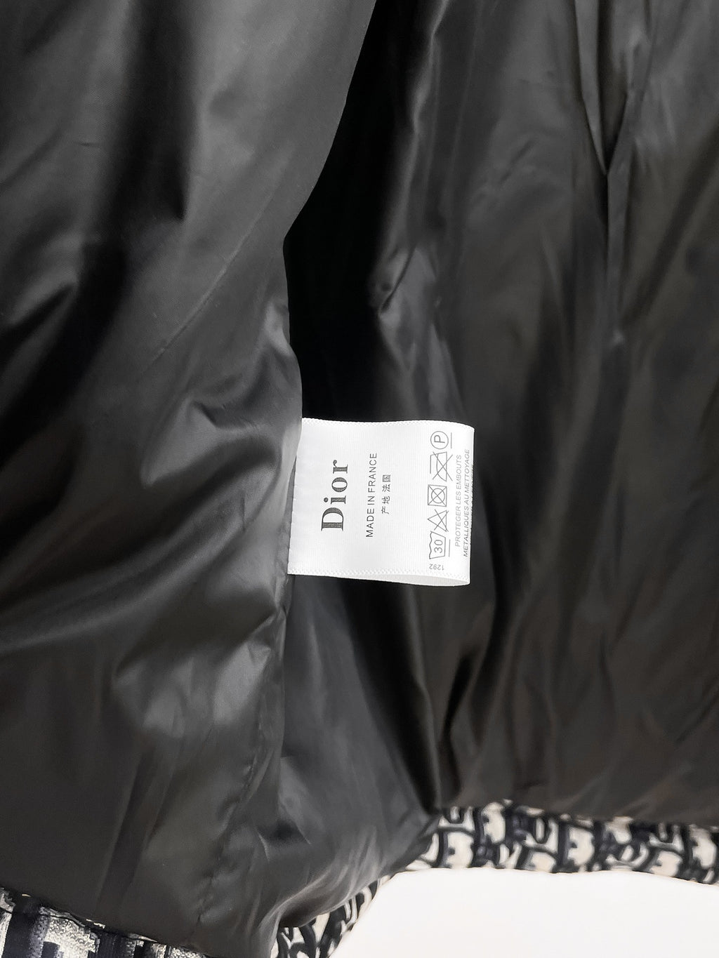 Long black Dior garment with white Dior care label