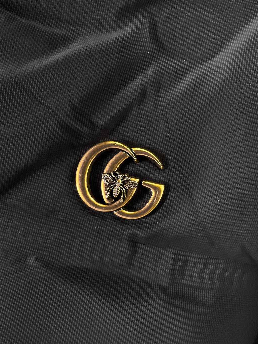 Long puffer jacket fabric with gold GG emblem