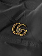 Long puffer jacket fabric with gold GG emblem