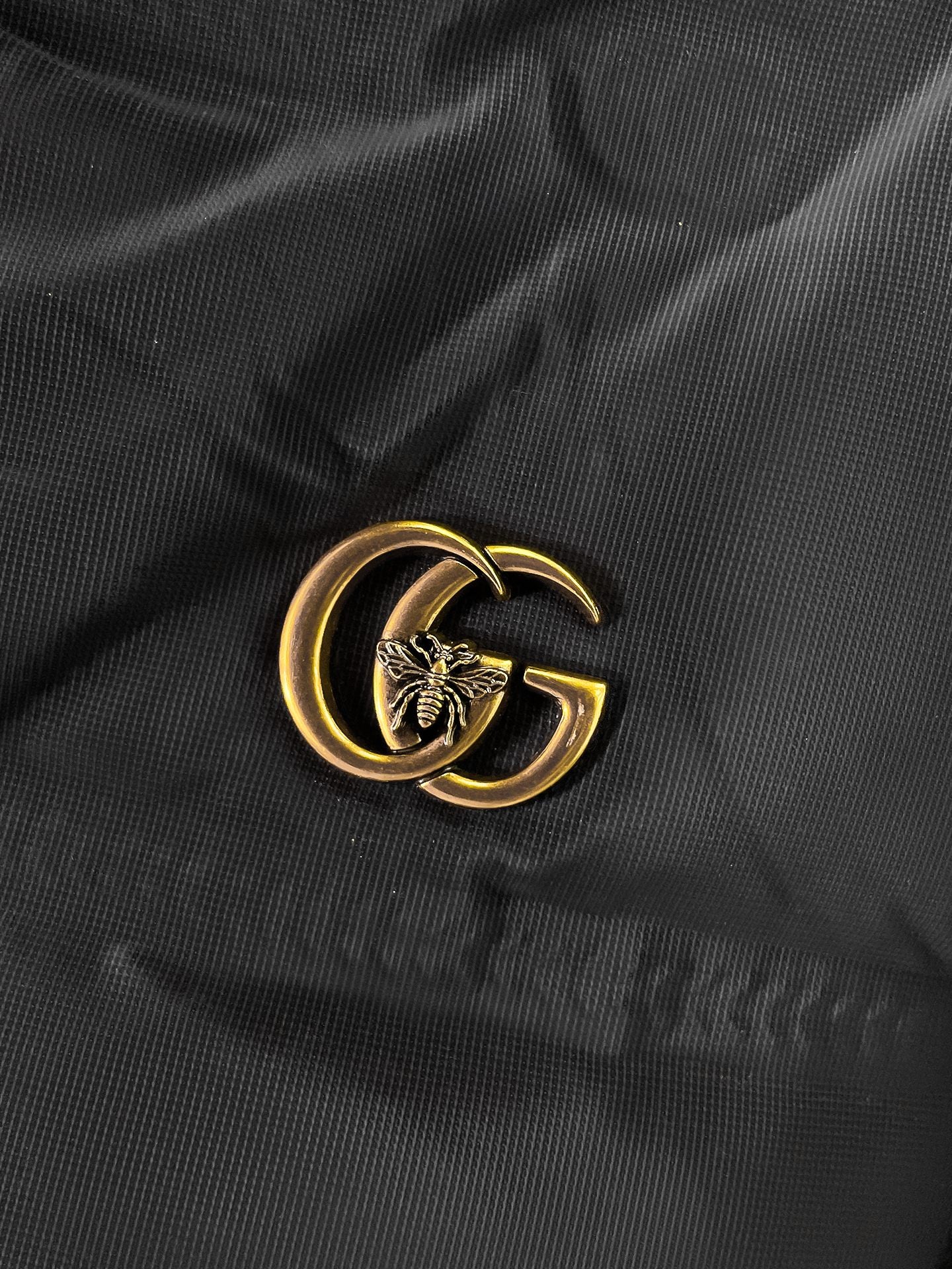 Long puffer jacket fabric with gold GG emblem