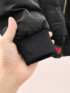 Long puffer jacket sleeve cuff with ribbed knit and striped hem band