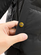 Long puffer jacket sleeve cuff with small round logo patch