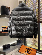 Black quilted puffer jacket, back view with horizontal baffles and snap collar