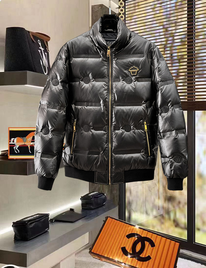 Black quilted puffer jacket with gold zipper and chest logo patch, front view