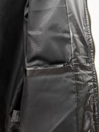 Black puffer jacket close-up of pocket and inner lining near zipper