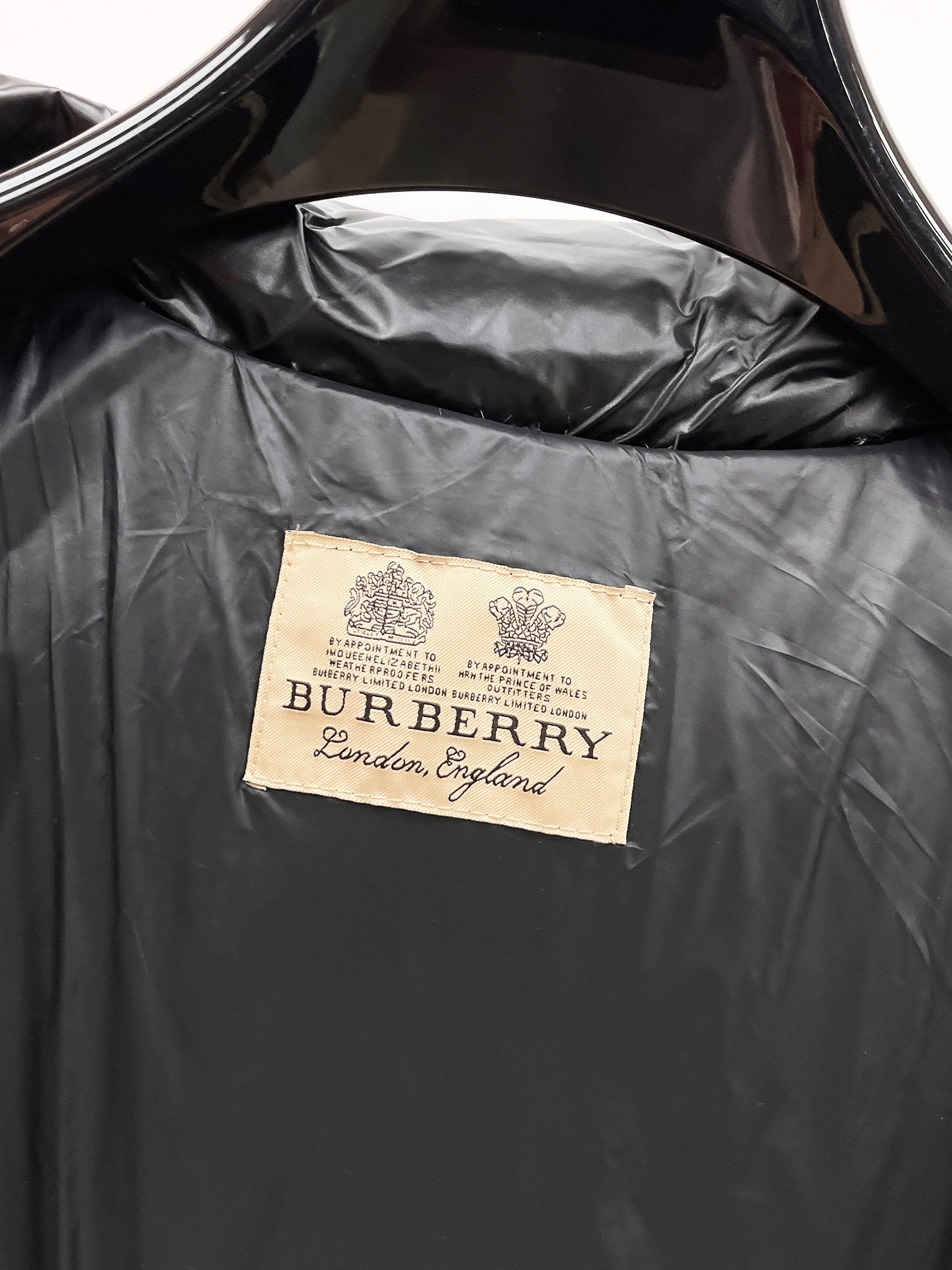 Burberry long puffer jacket, dark shiny black, interior lining with Burberry label.