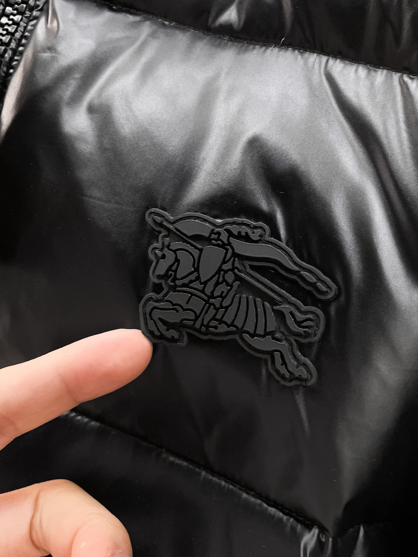 Black puffer jacket with embossed Burberry horse logo patch
