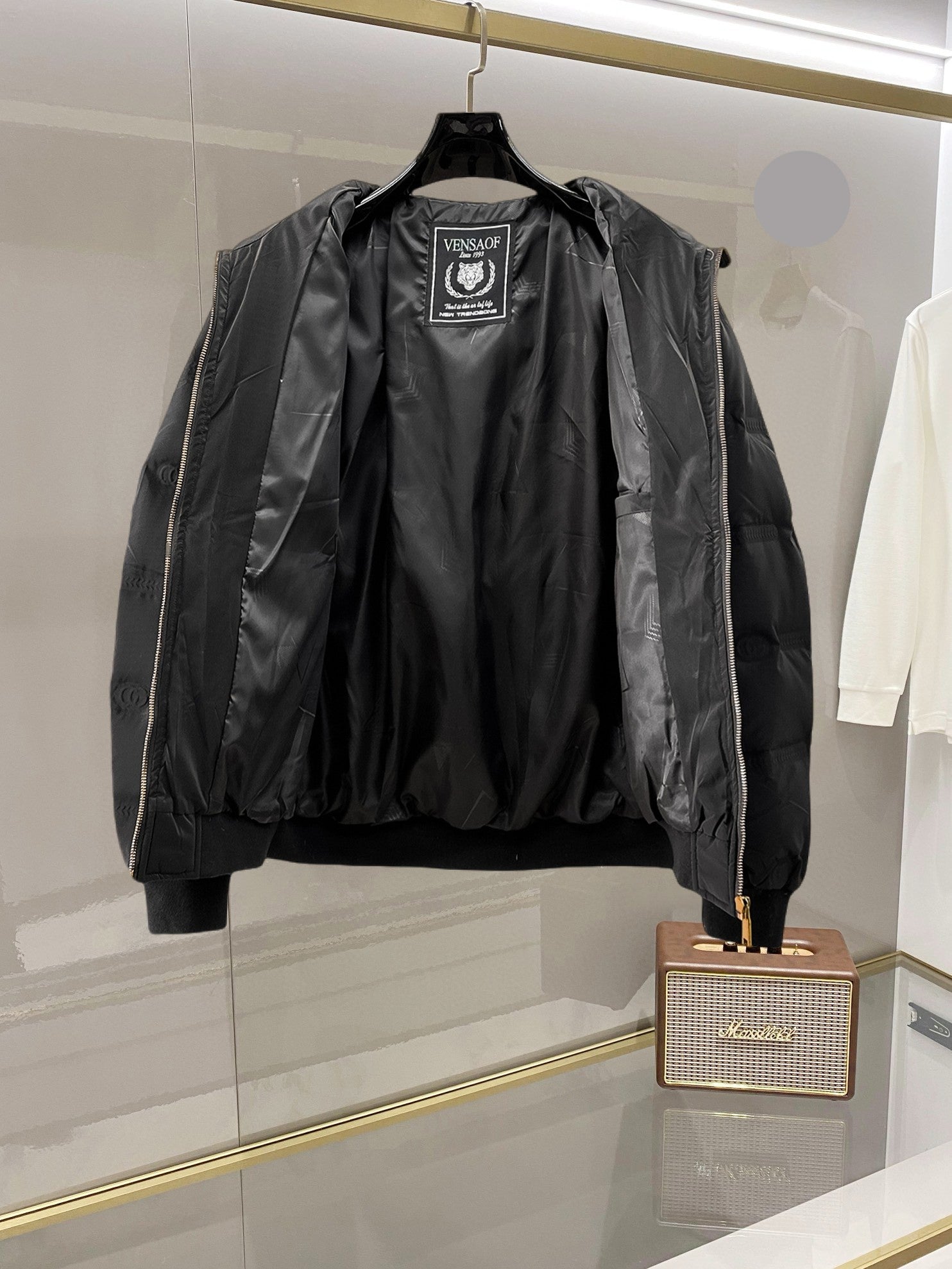 Long puffer jacket with hood, front zipper, and inner brand patch