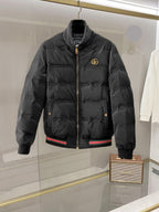 Gucci long puffer jacket with front zipper and gold GG logo on chest