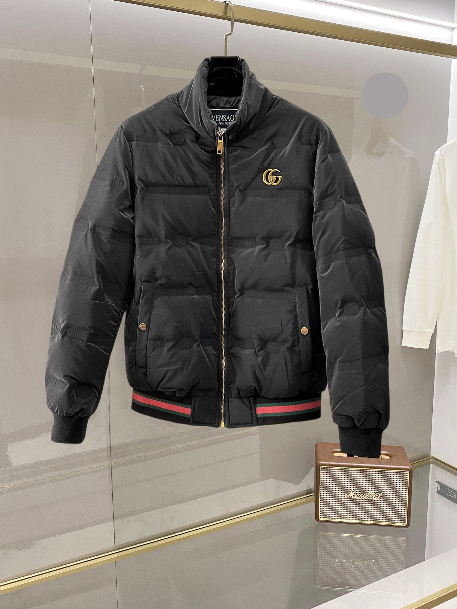 Gucci long puffer jacket with front zipper and gold GG logo on chest