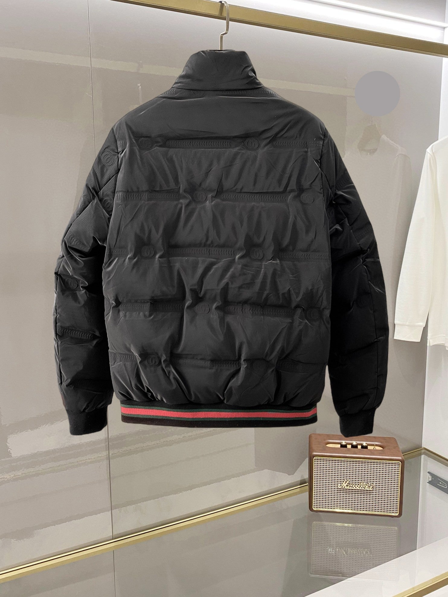 Long puffer jacket with hood, back view, front zipper and ribbed hem detail