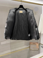 Burberry long puffer jacket, dark shiny black, front view with center zip and high collar.