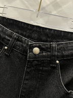 Black denim pants close-up of front button, waistband, and belt loops