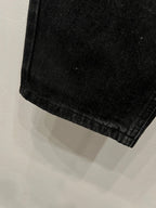 Black denim pants close-up of the lower cuff hem