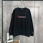 Black crewneck sweatshirt with lululemon logo at chest