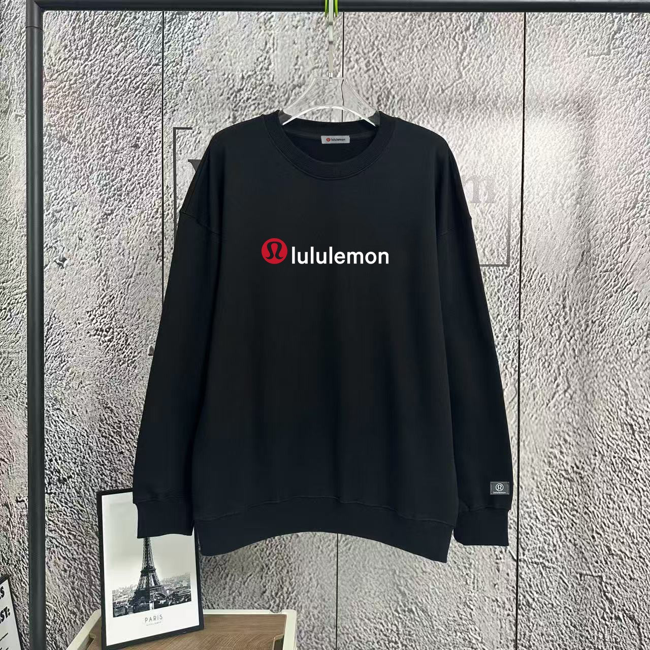 Black crewneck sweatshirt with lululemon logo at chest