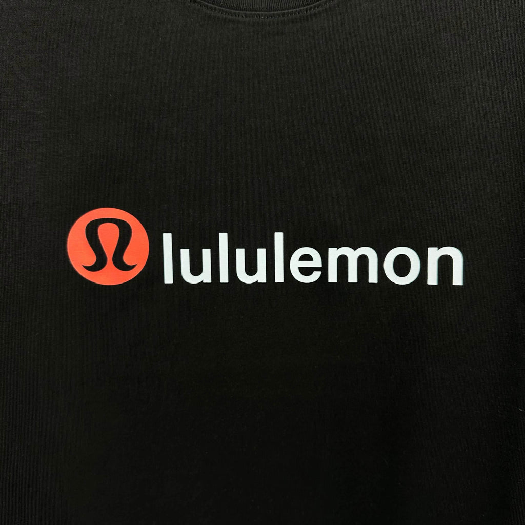 Black sweatshirt with red lululemon logo across chest