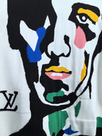 White sweater front with bold multicolor abstract face illustration in black outline