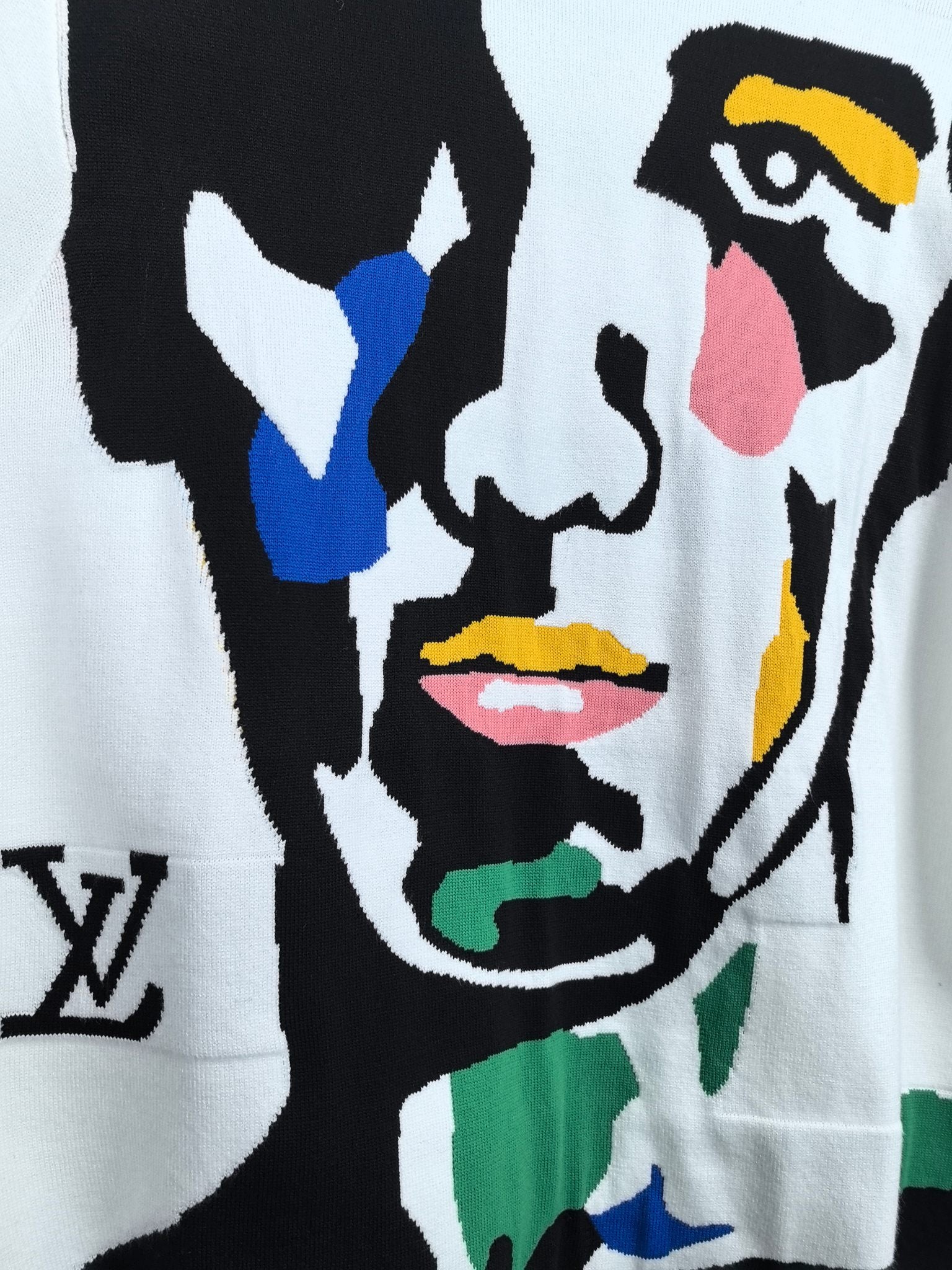 White sweater front with bold multicolor abstract face illustration in black outline
