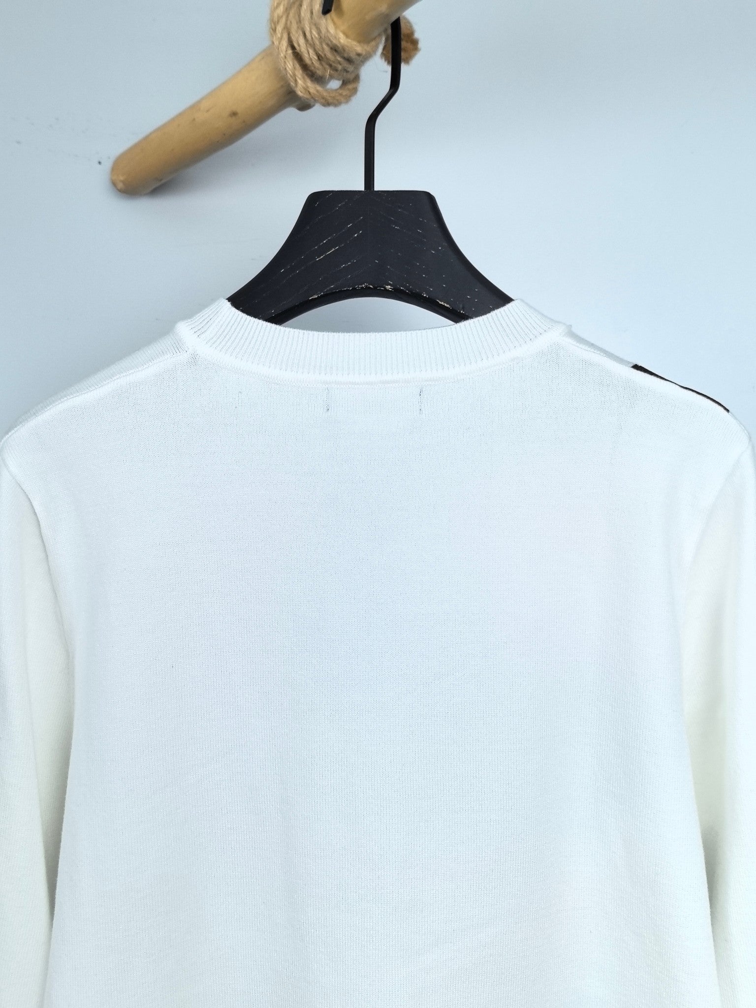 White long-sleeve crewneck sweater, plain back with neckline view
