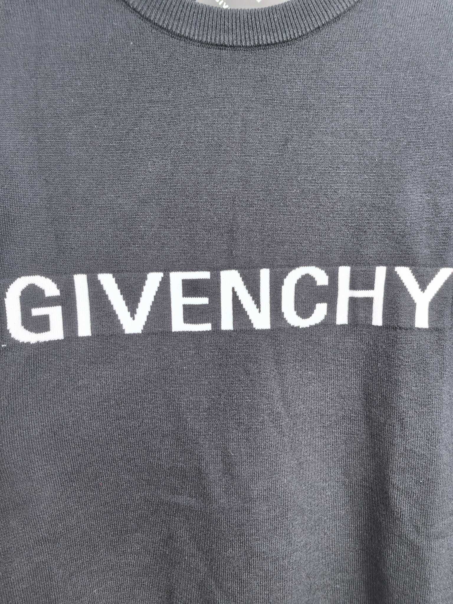 Dark sweatshirt with large white GIVENCHY lettering across the chest