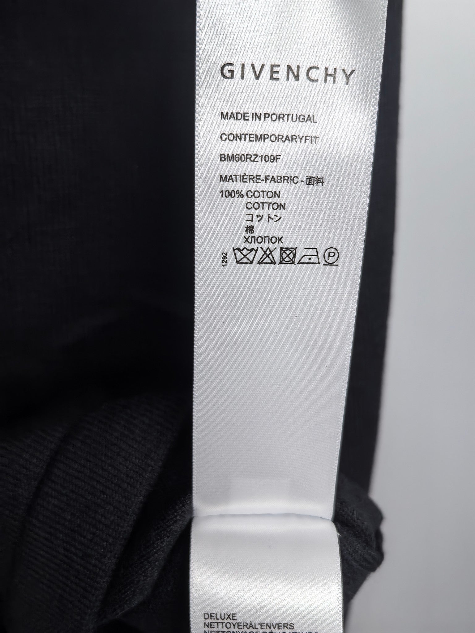 Black sweatshirt interior label reading Givenchy and 100% cotton