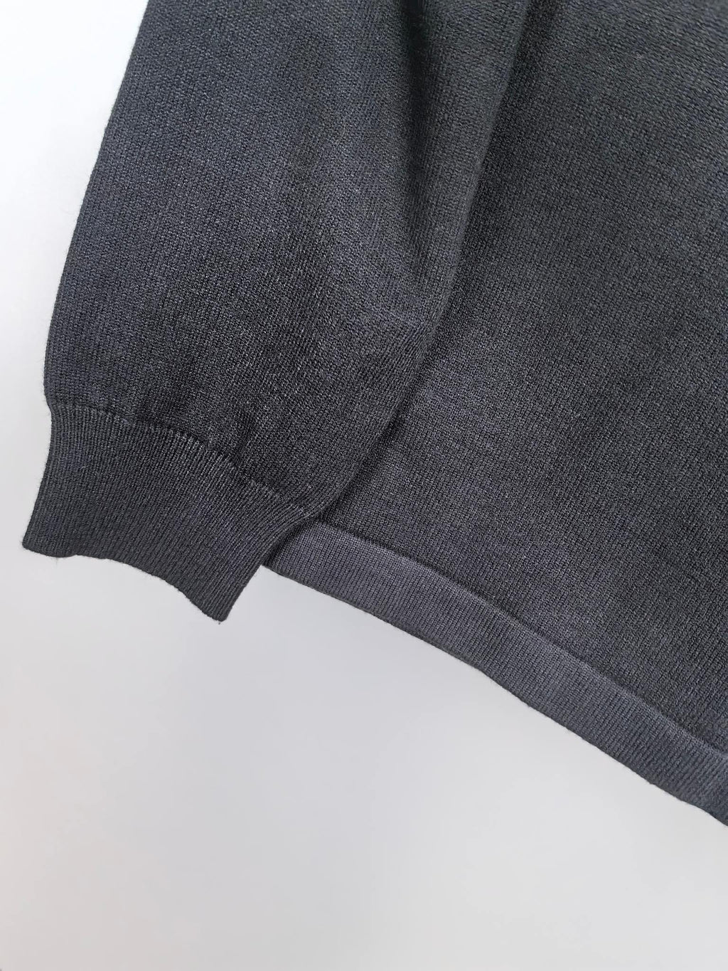 Dark sweatshirt ribbed cuff and knit sleeve seam detail