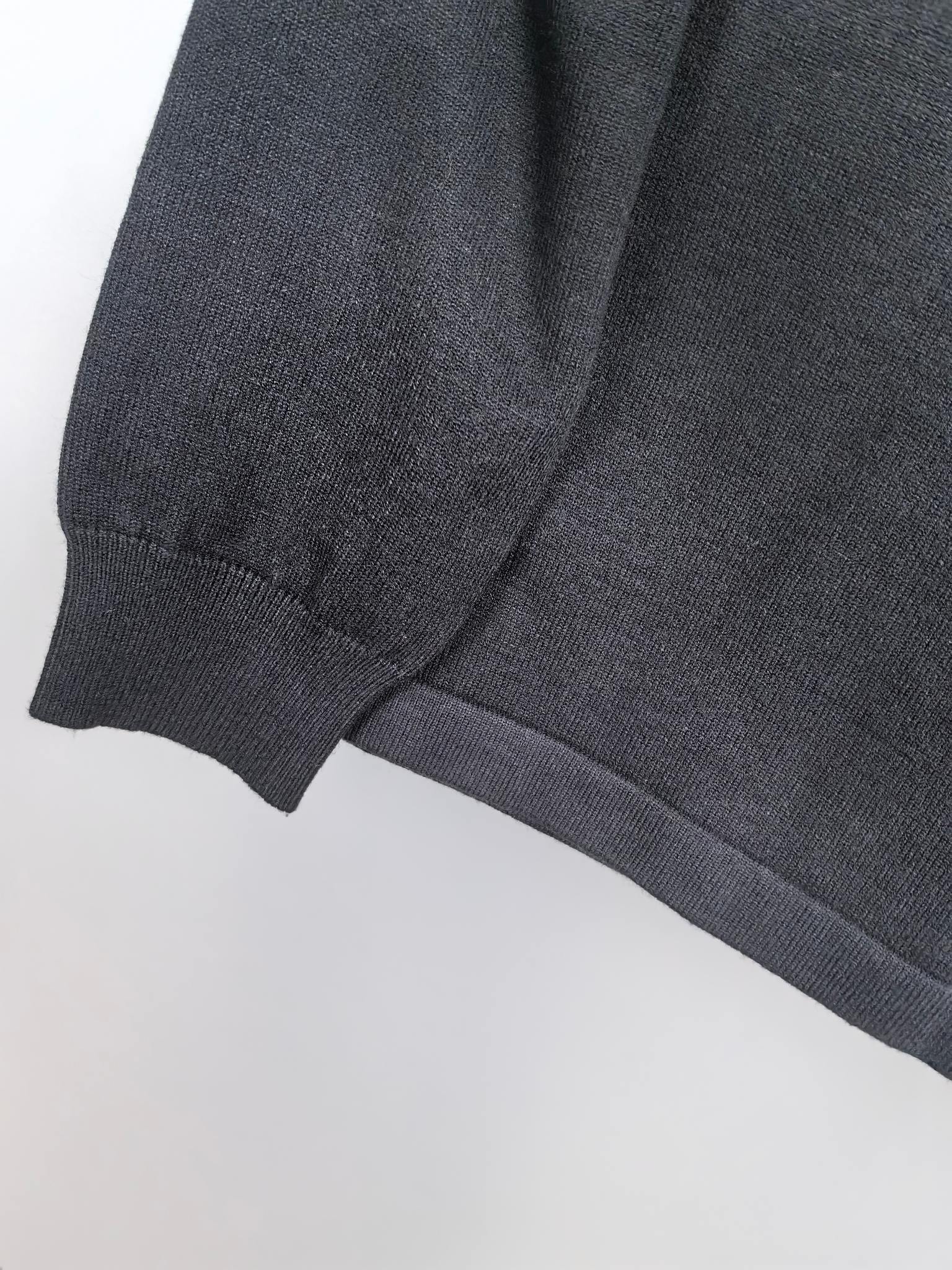 Dark sweatshirt ribbed cuff and knit sleeve seam detail