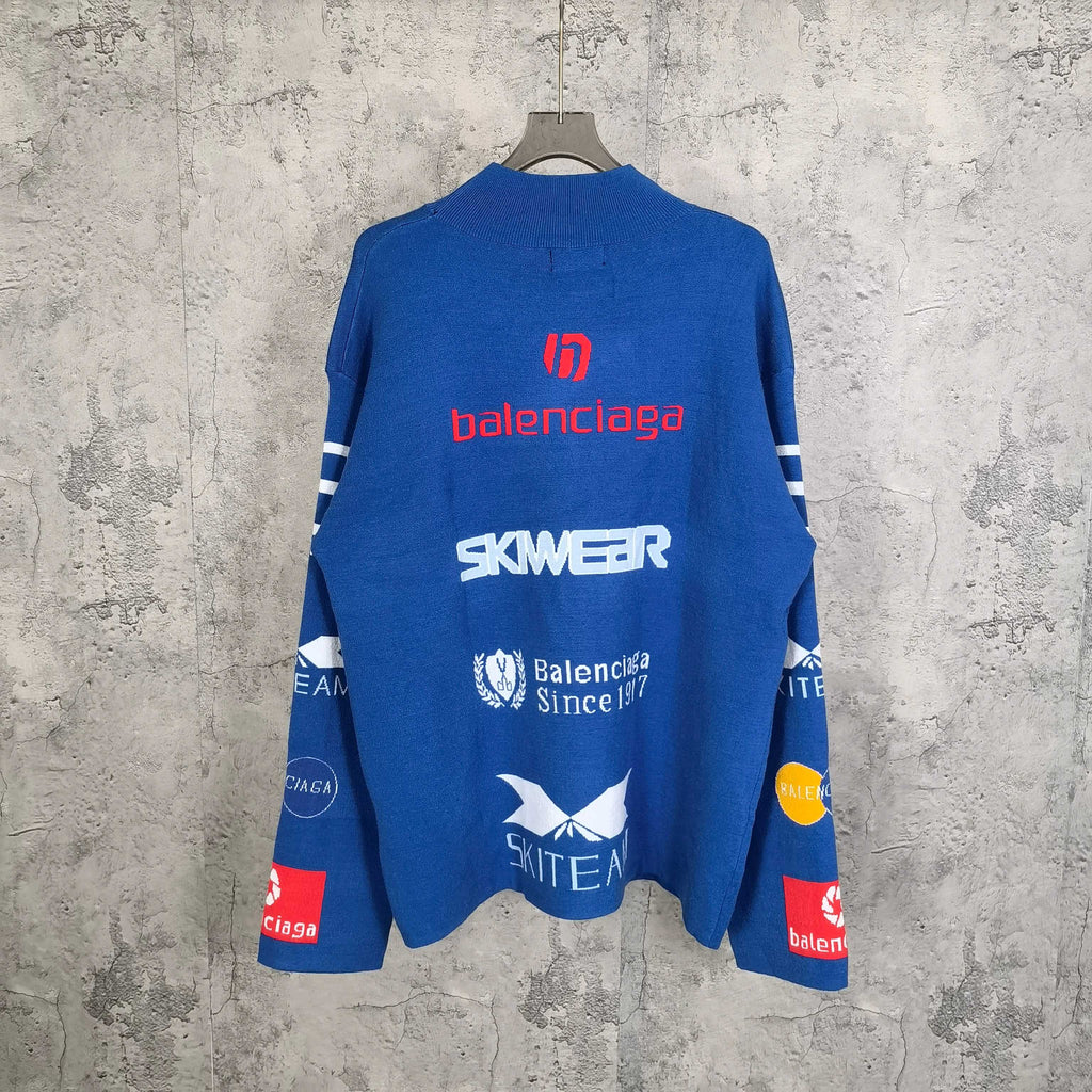 Blue long-sleeve sweater with back logo text and emblem patches