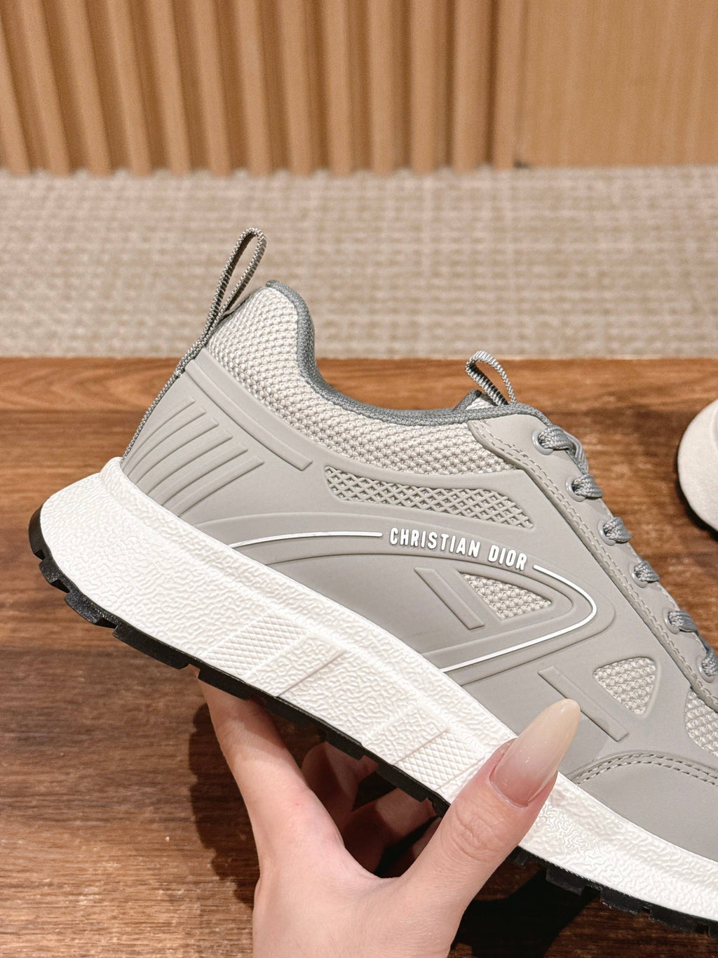 Light gray sneaker with thick sole and “CHRISTIAN DIOR” side detail