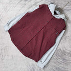 Folded red and black check vest with light gray hood and long sleeves