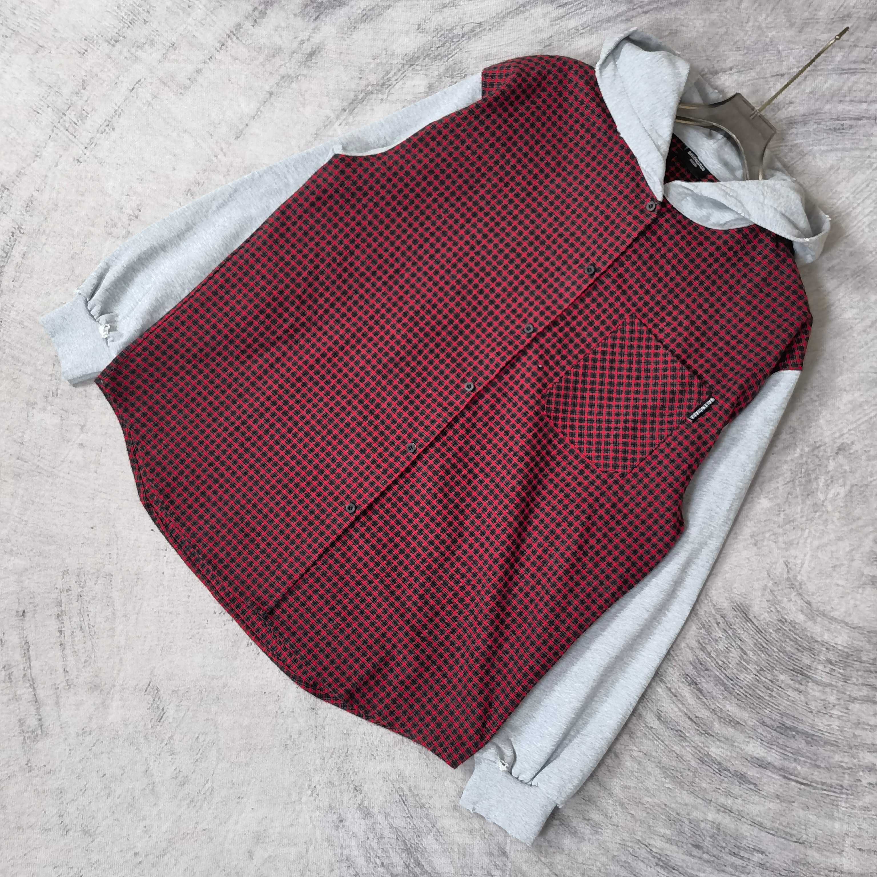 Folded red and black check vest with light gray hood and long sleeves